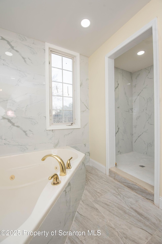 bathroom with marble finish floor, a jetted tub, recessed lighting, and a marble finish shower