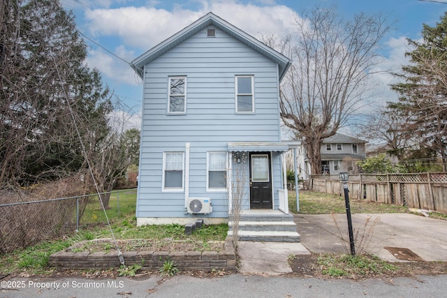 view of front of home with fence, a patio area, and ac unit