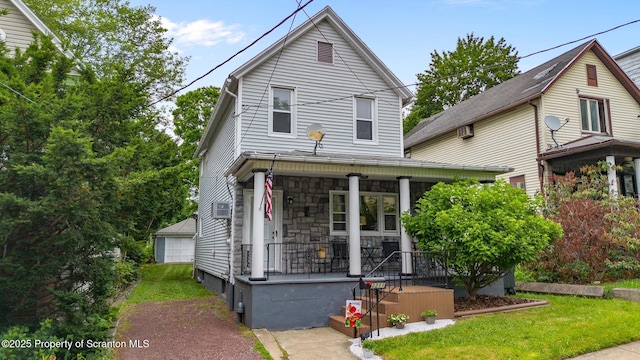 2211 Myrtle St, Scranton, PA 18510 - view of front of home with a porch, stone siding, an outbuilding, and a front lawn