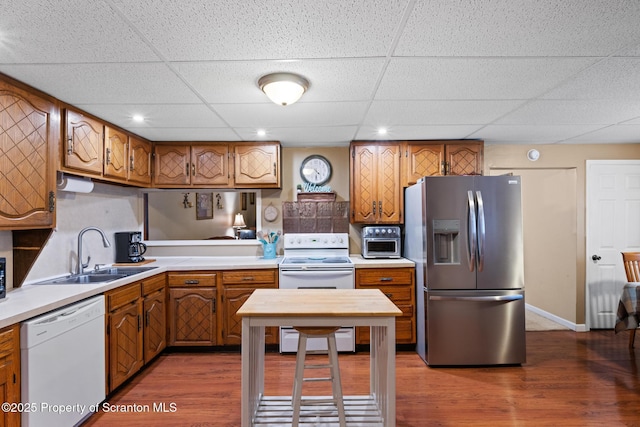 2211 Myrtle St, Scranton, PA 18510 - kitchen featuring white appliances, brown cabinetry, a drop ceiling, light countertops, and wood finished floors