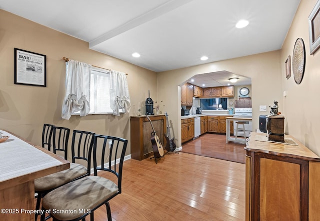2211 Myrtle St, Scranton, PA 18510 - kitchen featuring white appliances, arched walkways, brown cabinets, light wood finished floors, and recessed lighting