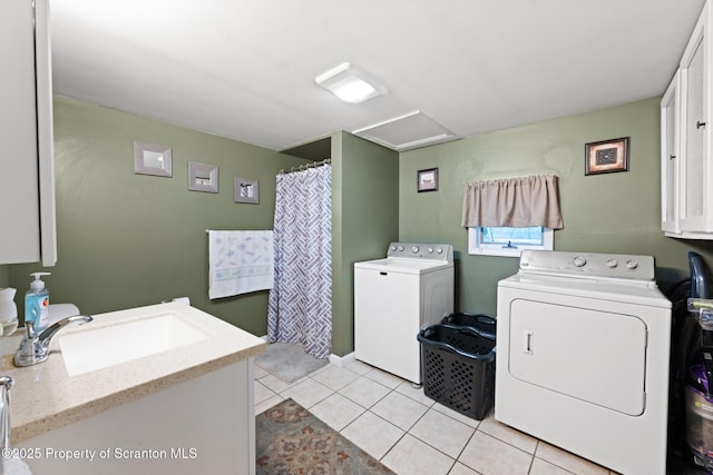 2211 Myrtle St, Scranton, PA 18510 - washroom featuring washer and dryer, cabinet space, light tile patterned flooring, and attic access