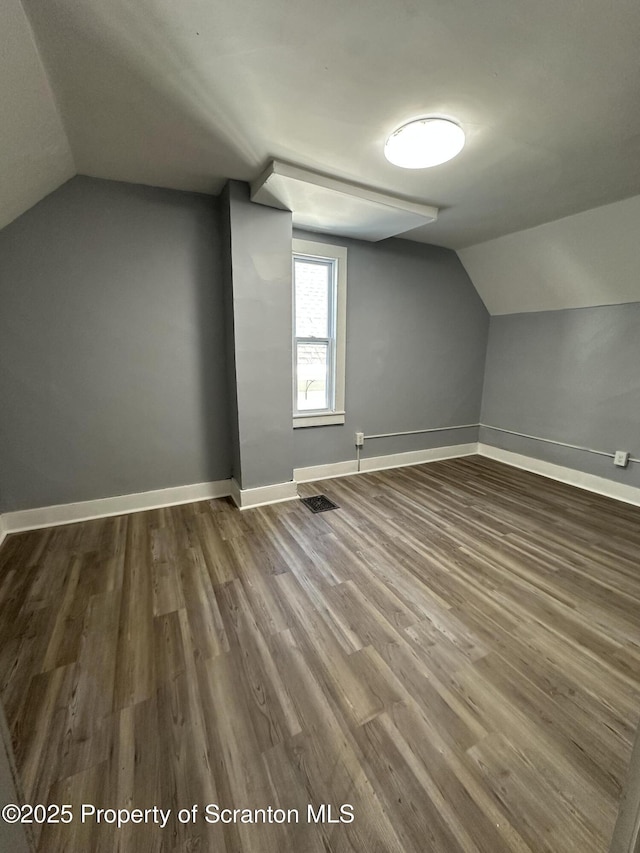 1353 Capouse 1351, Scranton, PA 18510 - additional living space featuring visible vents, baseboards, vaulted ceiling, and dark wood finished floors