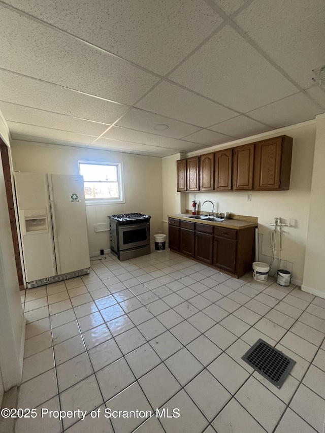 1353 Capouse 1351, Scranton, PA 18510 - kitchen featuring light tile patterned floors, a sink, stainless steel range with gas cooktop, white refrigerator with ice dispenser, and a drop ceiling