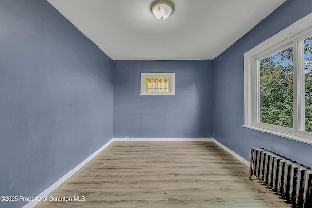 826 Moltke Ave, Scranton, PA 18505 - spare room featuring radiator heating unit and wood finished floors