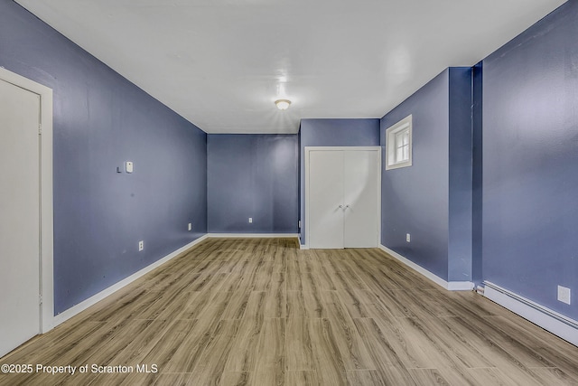 826 Moltke Ave, Scranton, PA 18505 - empty room featuring wood finished floors and a baseboard radiator