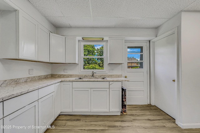 826 Moltke Ave, Scranton, PA 18505 - kitchen with a drop ceiling, white cabinets, and light wood-type flooring