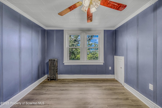 826 Moltke Ave, Scranton, PA 18505 - spare room featuring ornamental molding, ceiling fan, wood finished floors, and radiator heating unit