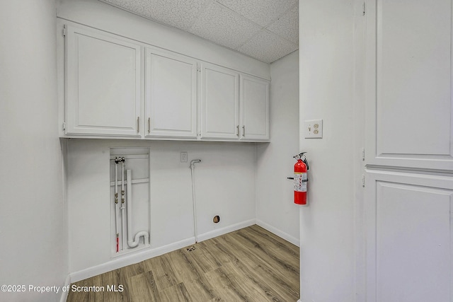 826 Moltke Ave, Scranton, PA 18505 - laundry area with cabinet space, light wood finished floors, and washer hookup