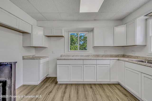 826 Moltke Ave, Scranton, PA 18505 - kitchen with white cabinetry, light wood-type flooring, light countertops, and a drop ceiling