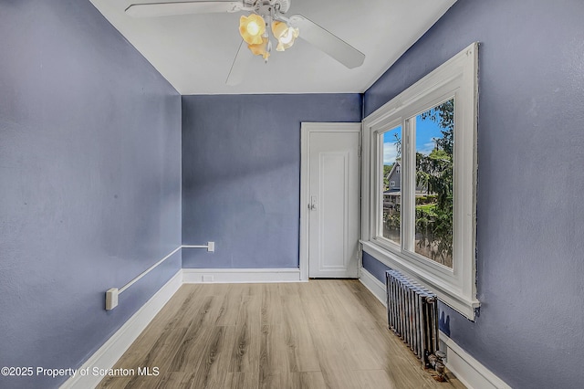 826 Moltke Ave, Scranton, PA 18505 - spare room featuring radiator, ceiling fan, and wood finished floors