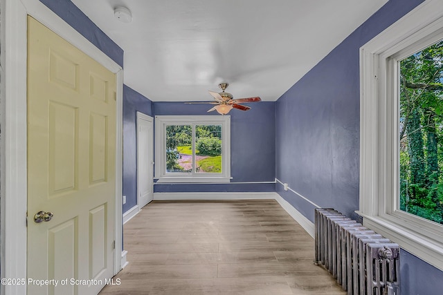 826 Moltke Ave, Scranton, PA 18505 - empty room featuring healthy amount of natural light, radiator, wood finished floors, and a ceiling fan