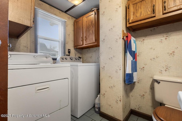 clothes washing area with laundry area, light tile patterned floors, independent washer and dryer, and wallpapered walls