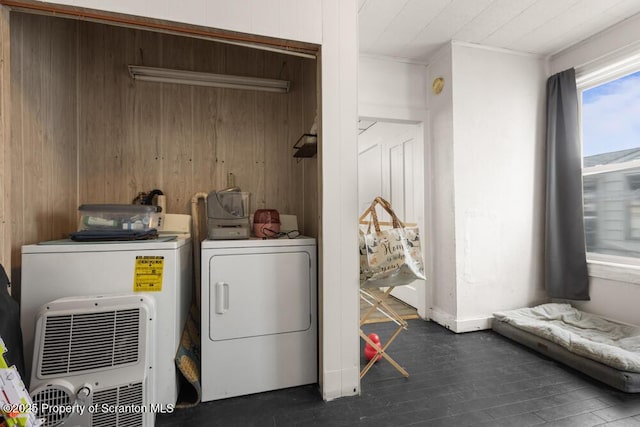 laundry room featuring dark wood-style floors, washer and dryer, laundry area, and wooden walls