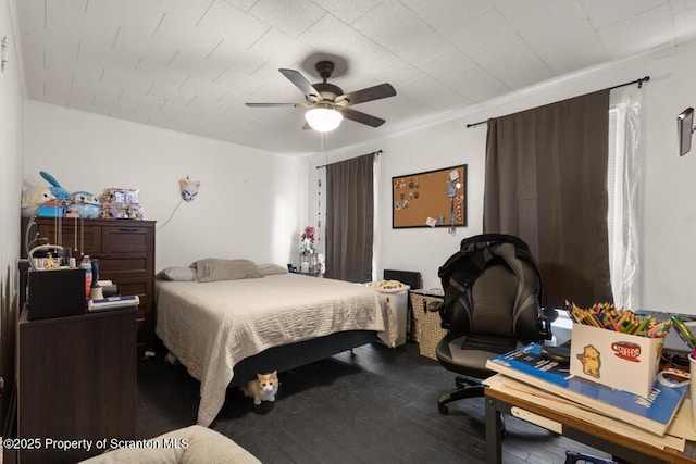 bedroom featuring wood finished floors and a ceiling fan