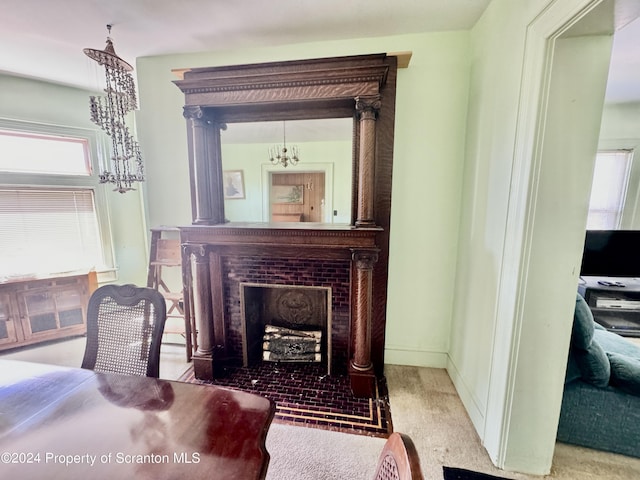 interior space with an inviting chandelier, a fireplace with flush hearth, and baseboards