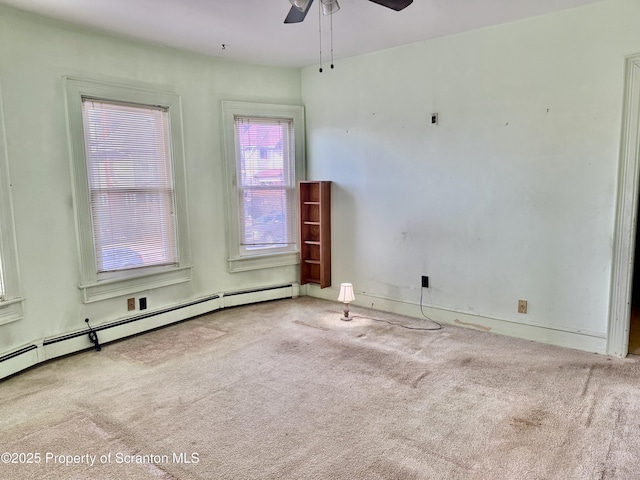 spare room featuring ceiling fan, baseboard heating, and carpet flooring