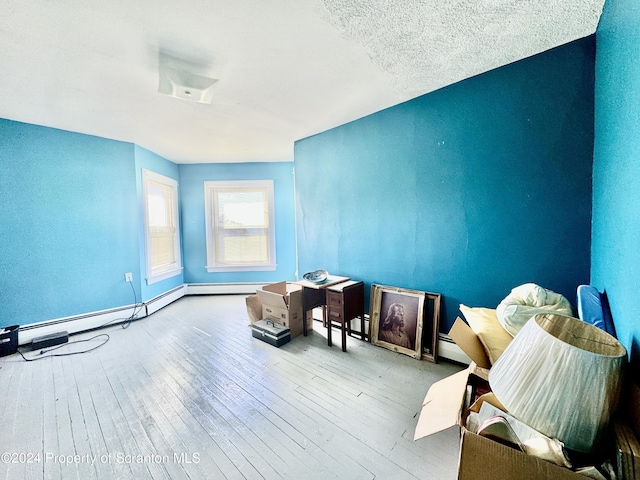 interior space with wood-type flooring and a baseboard radiator