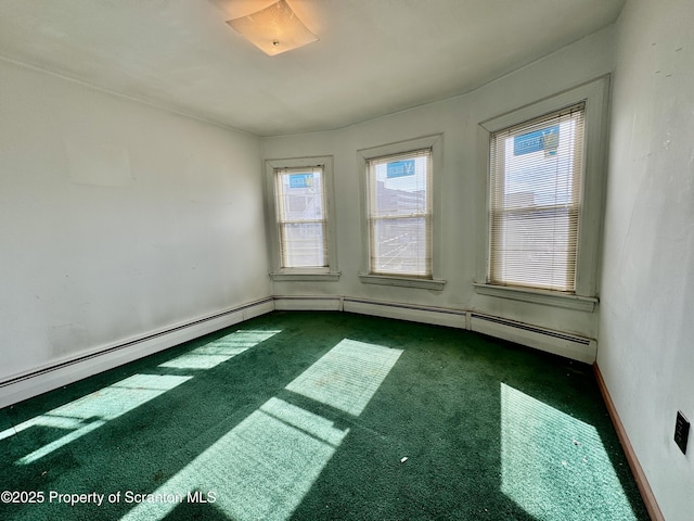 empty room featuring baseboards and dark carpet