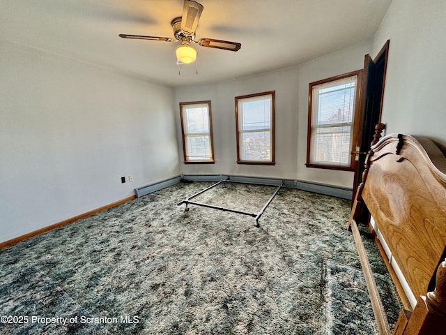 interior space with carpet, ceiling fan, baseboards, and a baseboard radiator