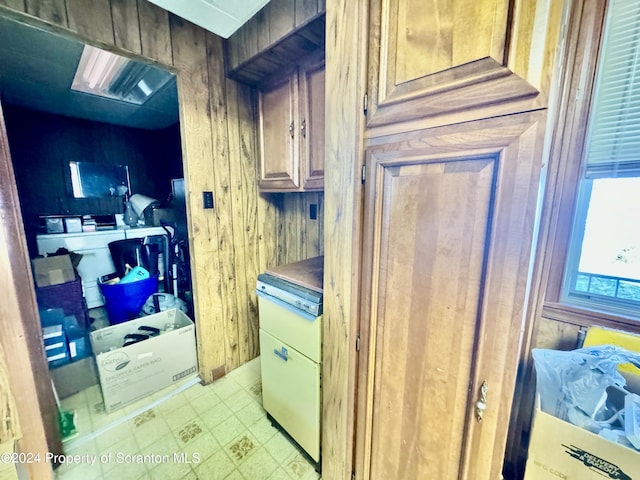 clothes washing area featuring wooden walls