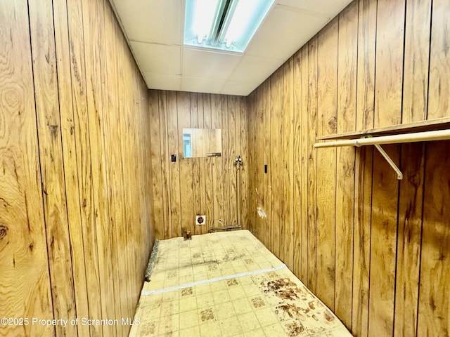 washroom featuring wood walls