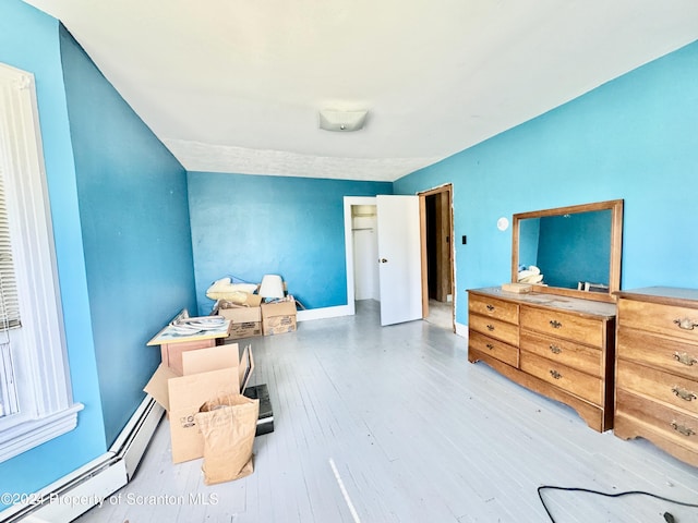 bedroom featuring hardwood / wood-style floors and baseboard heating