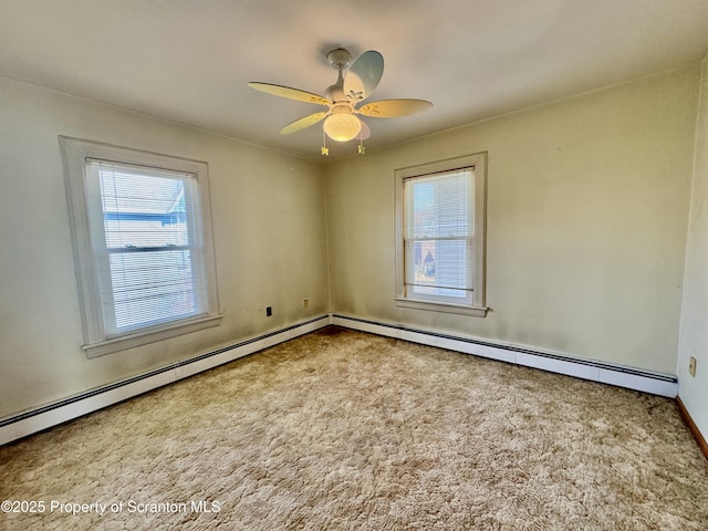 carpeted spare room featuring a ceiling fan and a baseboard radiator