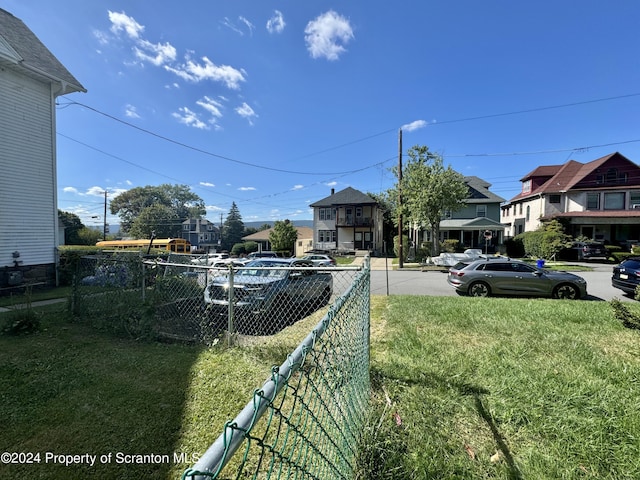 view of yard with a residential view and fence