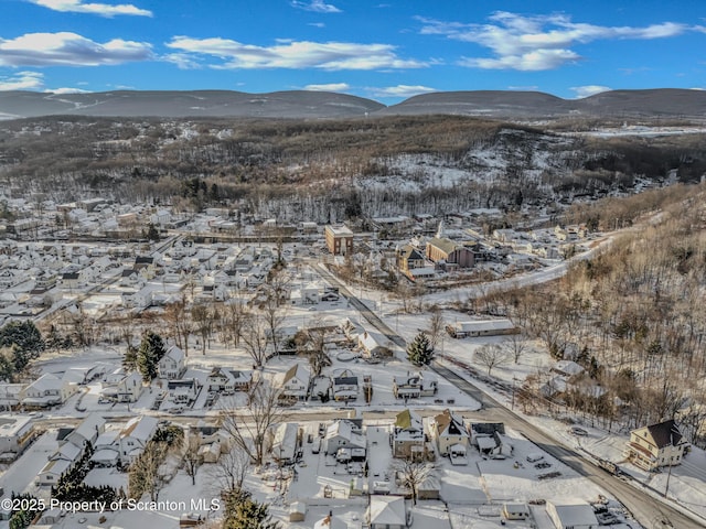 snowy aerial view with a mountain view