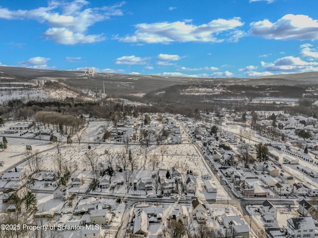 snowy aerial view with a mountain view