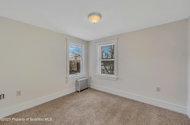 carpeted empty room featuring radiator