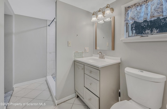 bathroom with walk in shower, tile patterned floors, vanity, and toilet