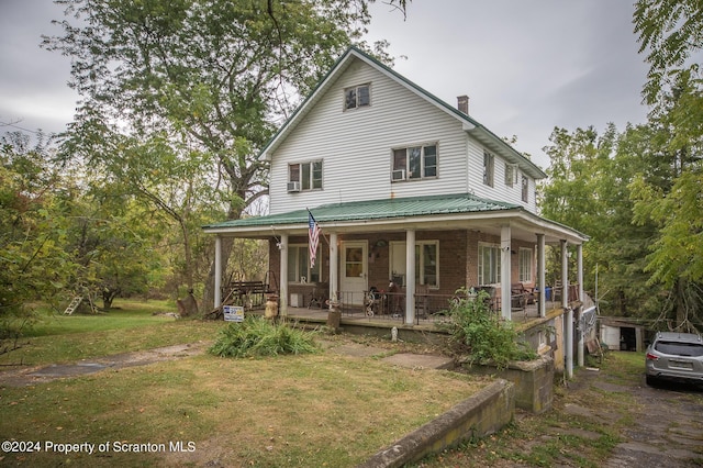 farmhouse with a porch and a front yard