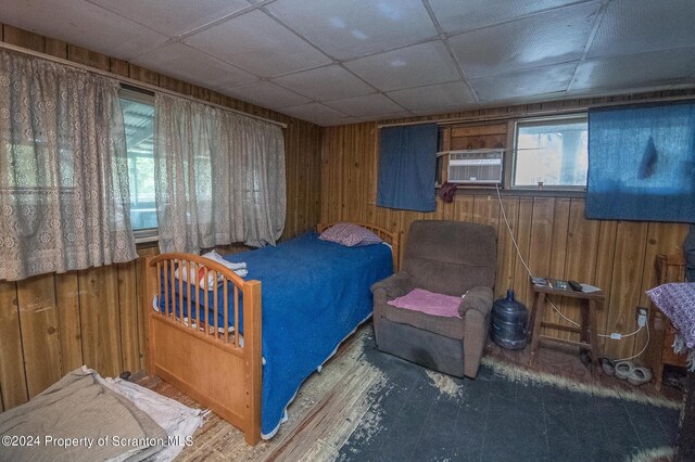 bedroom featuring wood walls