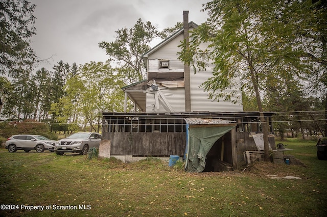 view of side of home with a yard