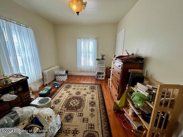 interior space with hardwood / wood-style floors and radiator