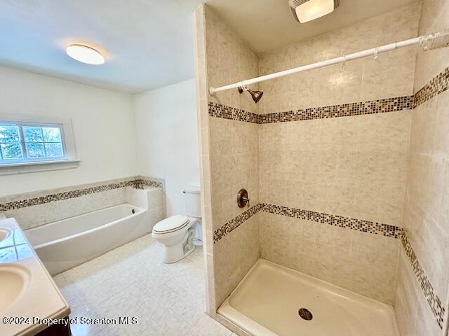 full bathroom with tile patterned floors, vanity, separate shower and tub, and toilet