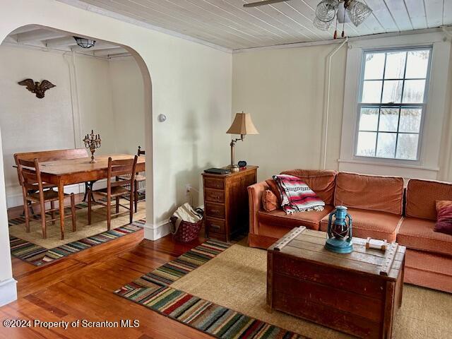 living room with ceiling fan, wood ceiling, and wood-type flooring