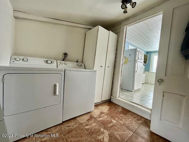 laundry area featuring washing machine and dryer and tile patterned floors