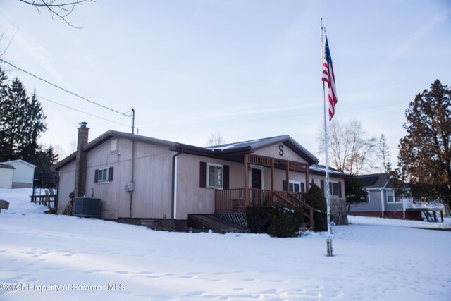 snow covered property with cooling unit