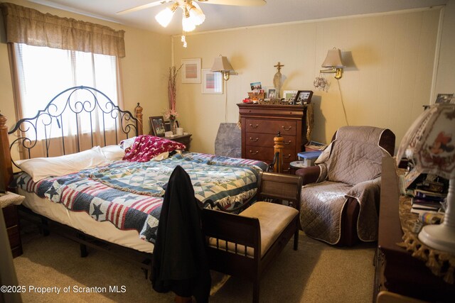 bedroom featuring crown molding, carpet, and ceiling fan