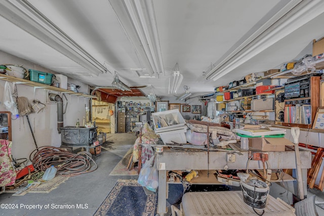 interior space with a workshop area, a wood stove, and concrete flooring