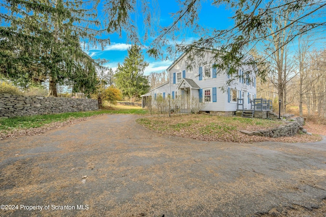 view of property exterior with a deck