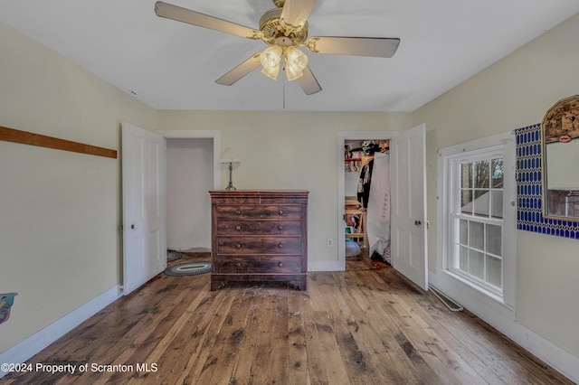 unfurnished bedroom with hardwood / wood-style floors, a closet, and ceiling fan