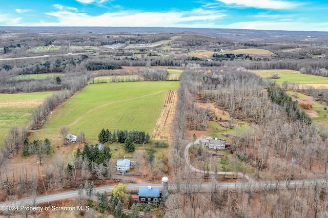 birds eye view of property with a rural view