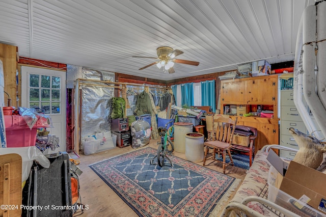 interior space with ceiling fan