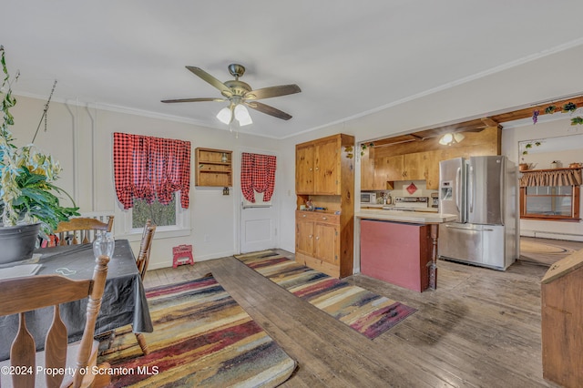 kitchen featuring stainless steel refrigerator with ice dispenser, stove, ceiling fan, crown molding, and light hardwood / wood-style flooring