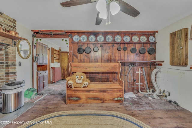 interior space with wood-type flooring and ceiling fan