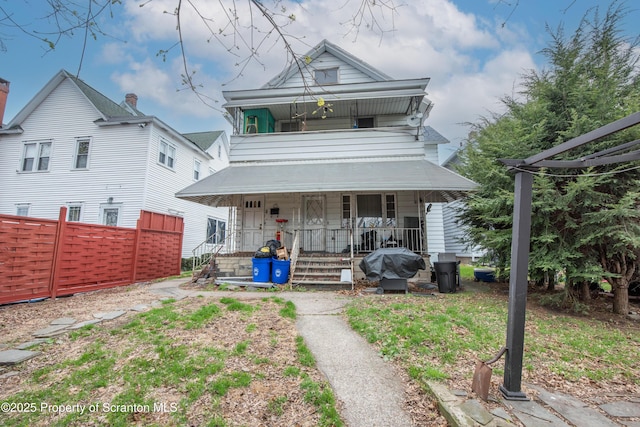 view of front facade with a porch and fence